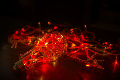 Close-up of illuminated lighting equipment on table