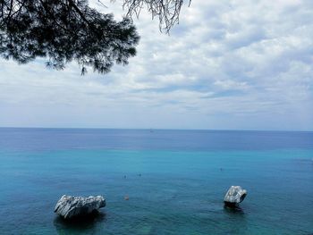 Scenic view of sea against cloudy sky