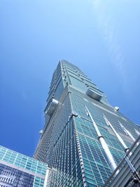 Low angle view of skyscraper against clear blue sky
