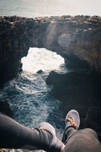 Low section of man by sea on cliff