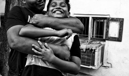Midsection of couple holding hands
