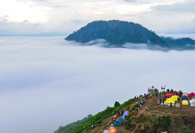 People on mountain against sky