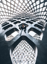 High angle portrait of man standing on ceiling