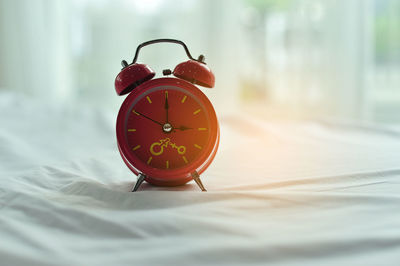 Close-up of clock on table at home