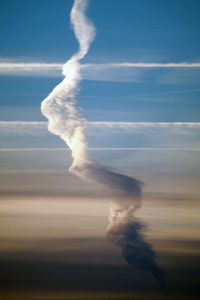 Smoke emitting from vapor trail in sky