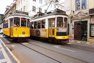 Yellow train on railroad tracks in city