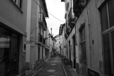 Street amidst buildings against sky