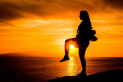 Silhouette of man at beach during sunset