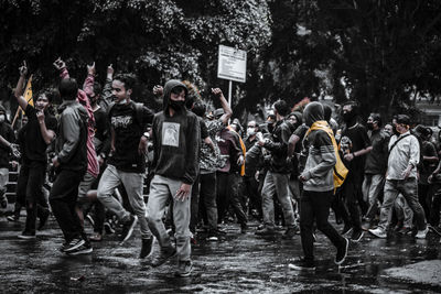 People standing on wet street in rain