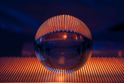 Close-up of illuminated lamp on table