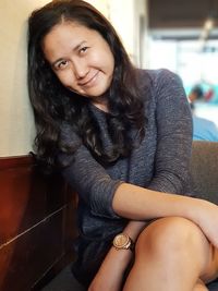 Portrait of beautiful young woman sitting