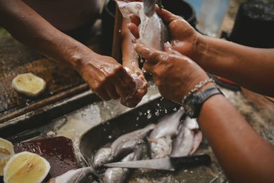 Close-up of people preparing food