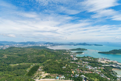 High angle view of city by sea against sky