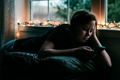 Girl looking at camera while sitting at home