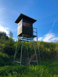 Low angle view of hut on field against sky