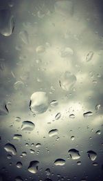 Full frame shot of raindrops on window