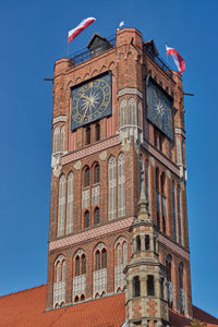 Low angle view of clock tower against blue sky