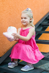 Side view of cute girl standing on staircase