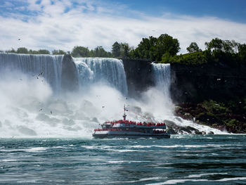 Scenic view of waterfall against sky