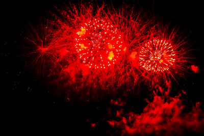 Low angle view of firework display against sky at night