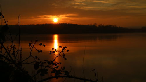 Scenic view of lake against sky during sunset