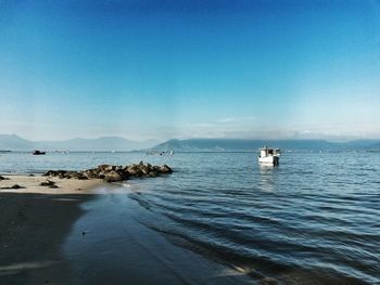 Scenic view of sea against blue sky