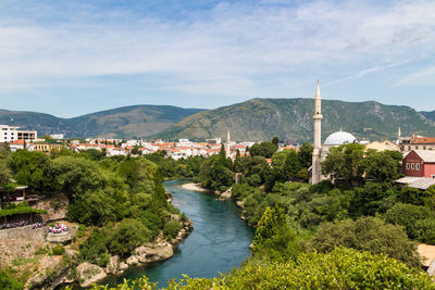 View of townscape by mountain against sky