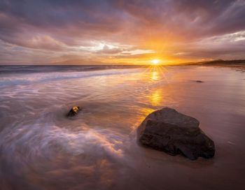 Scenic view of sea against sky at sunset