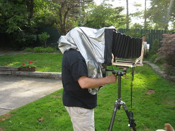 Side view of man with camera in park