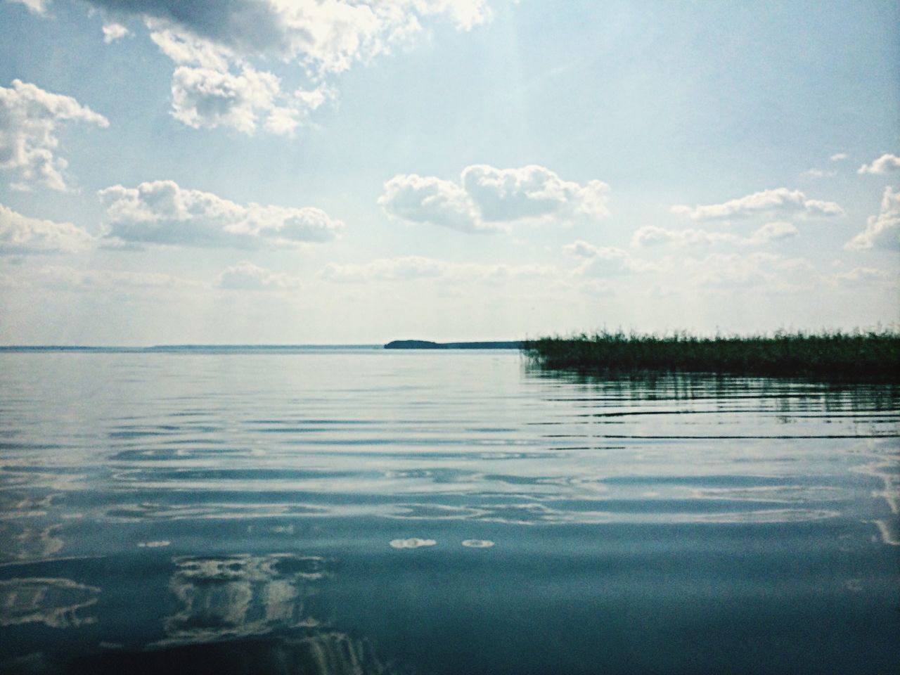 water, tranquil scene, tranquility, reflection, sky, scenics, waterfront, beauty in nature, nature, sea, lake, idyllic, cloud - sky, horizon over water, rippled, cloud, calm, outdoors, blue, no people