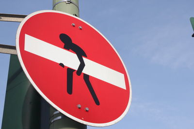 Low angle view of road sign against sky