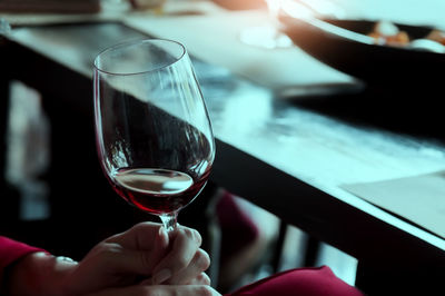 Close-up of hand holding wineglass