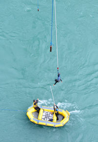High angle view of person bungee jumping over river