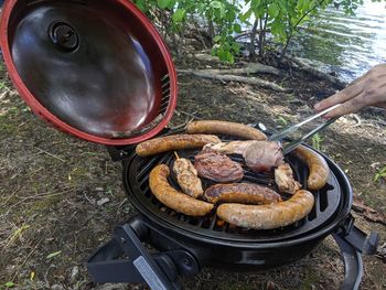 High angle view of person preparing food on barbecue grill