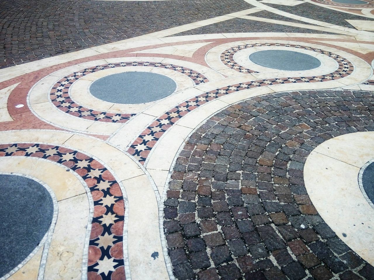 pattern, architecture, high angle view, mosaic, arch, no people, design, flooring, travel destinations, day, tiled floor, built structure, history, tile, the past, footpath, shape, travel, outdoors, geometric shape, paving stone, courtyard