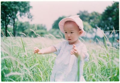 Cute baby girl on field