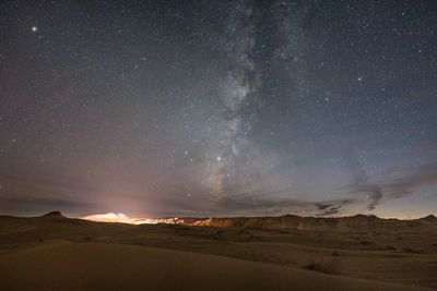 Scenic view of desert against sky at night
