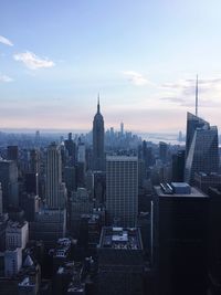 View of skyscrapers against cloudy sky