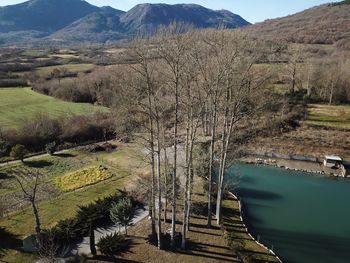 Scenic view of river by mountains against sky