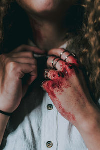 Midsection of woman with blood on hand