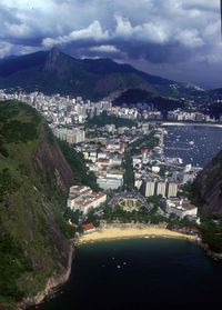 High angle view of city by sea and mountains