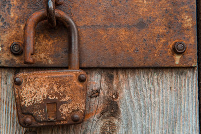 Close-up of padlock on closed door