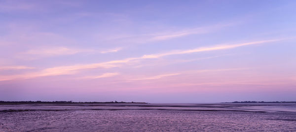 Scenic view of sea against romantic sky at sunset