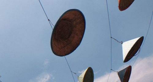 Low angle view of balloons against clear blue sky