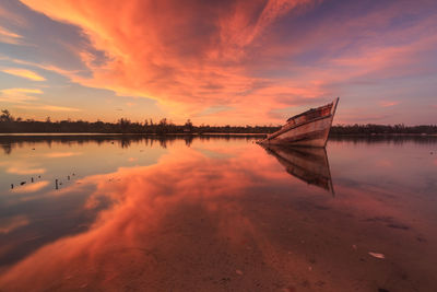 Scenic view of lake against sky during sunset