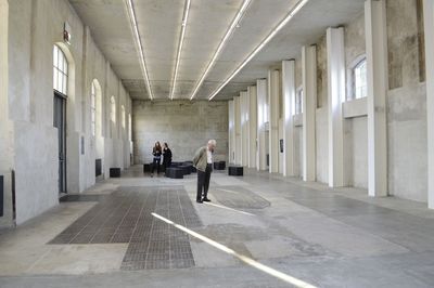 People walking in corridor of building