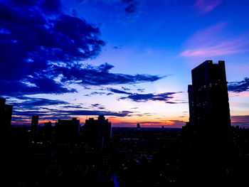 Silhouette cityscape against sky during sunset