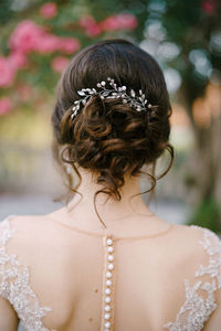 Rear view of woman with flower head