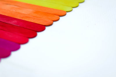 Close-up of multi colored pencils over white background