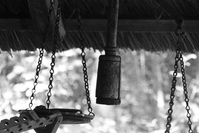 Low angle view of swing hanging on roof